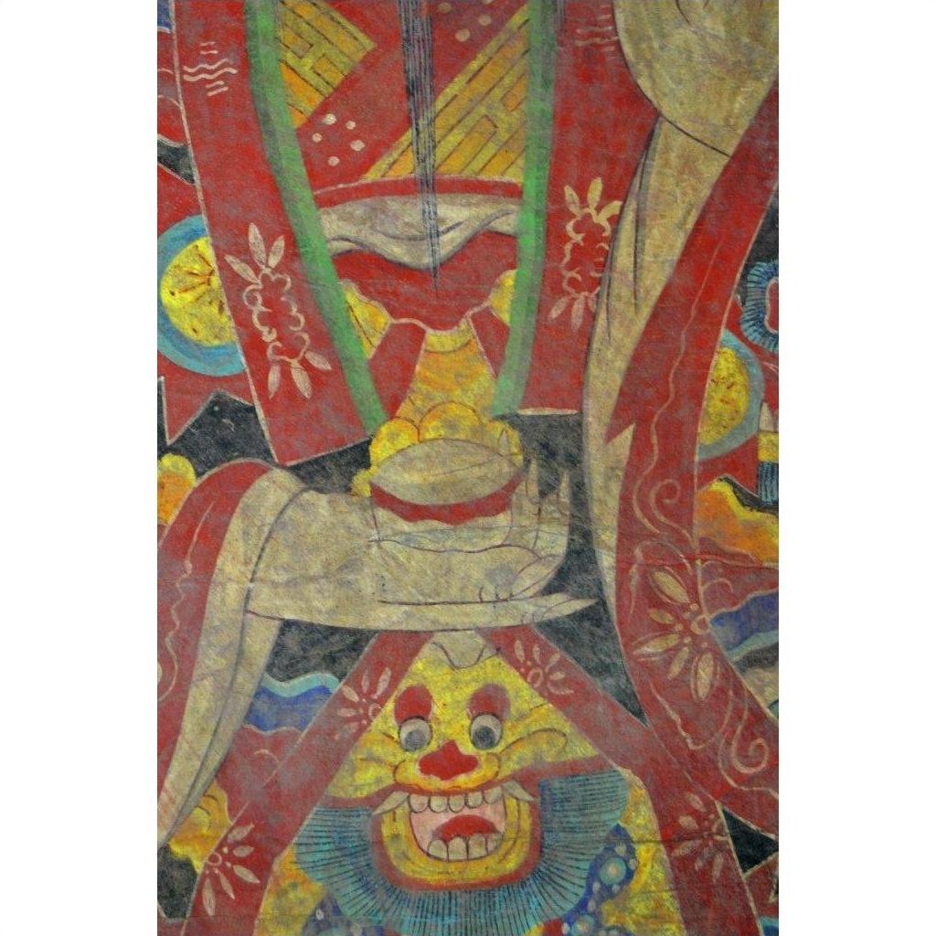 Close-up of Laotian parchment painting with stylized hands, bowl, and grinning blue-bearded face in double plexiglass.