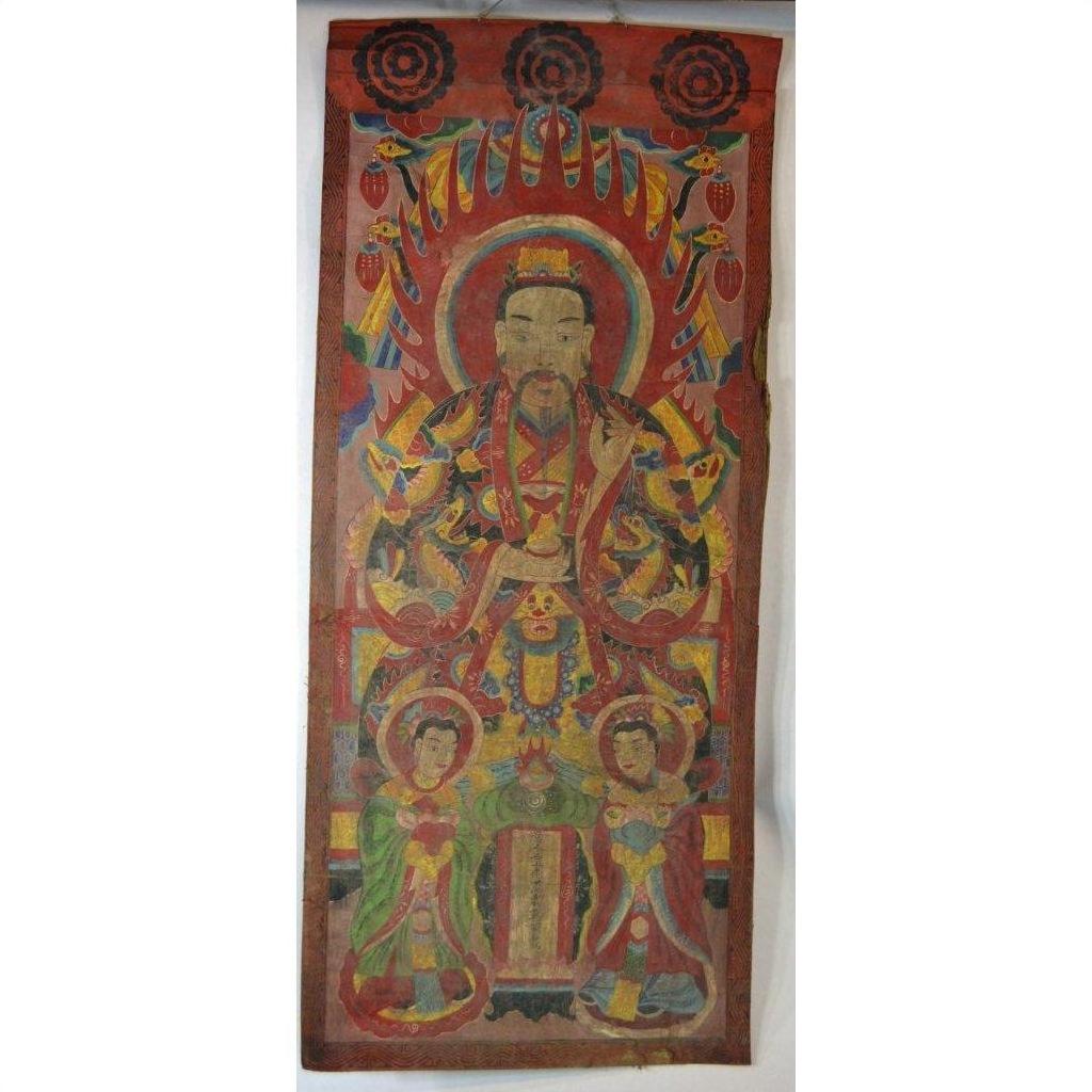 Colorful Laotian parchment painting in double plexiglass frame featuring ornately dressed figure with two smaller figures.