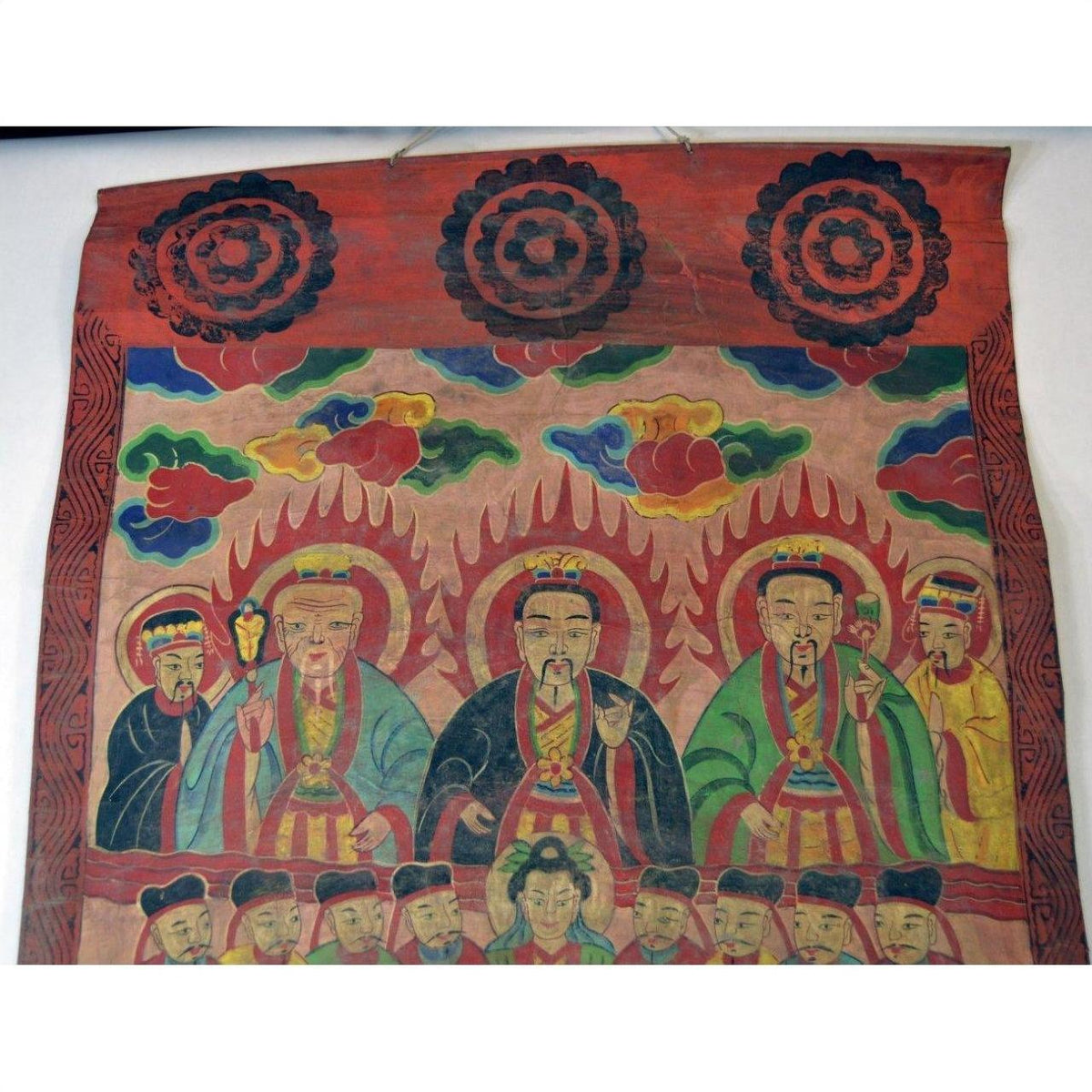 Colorful parchment painting of seated figures in robes with halos, clouds, and decorative patterns, in good condition.