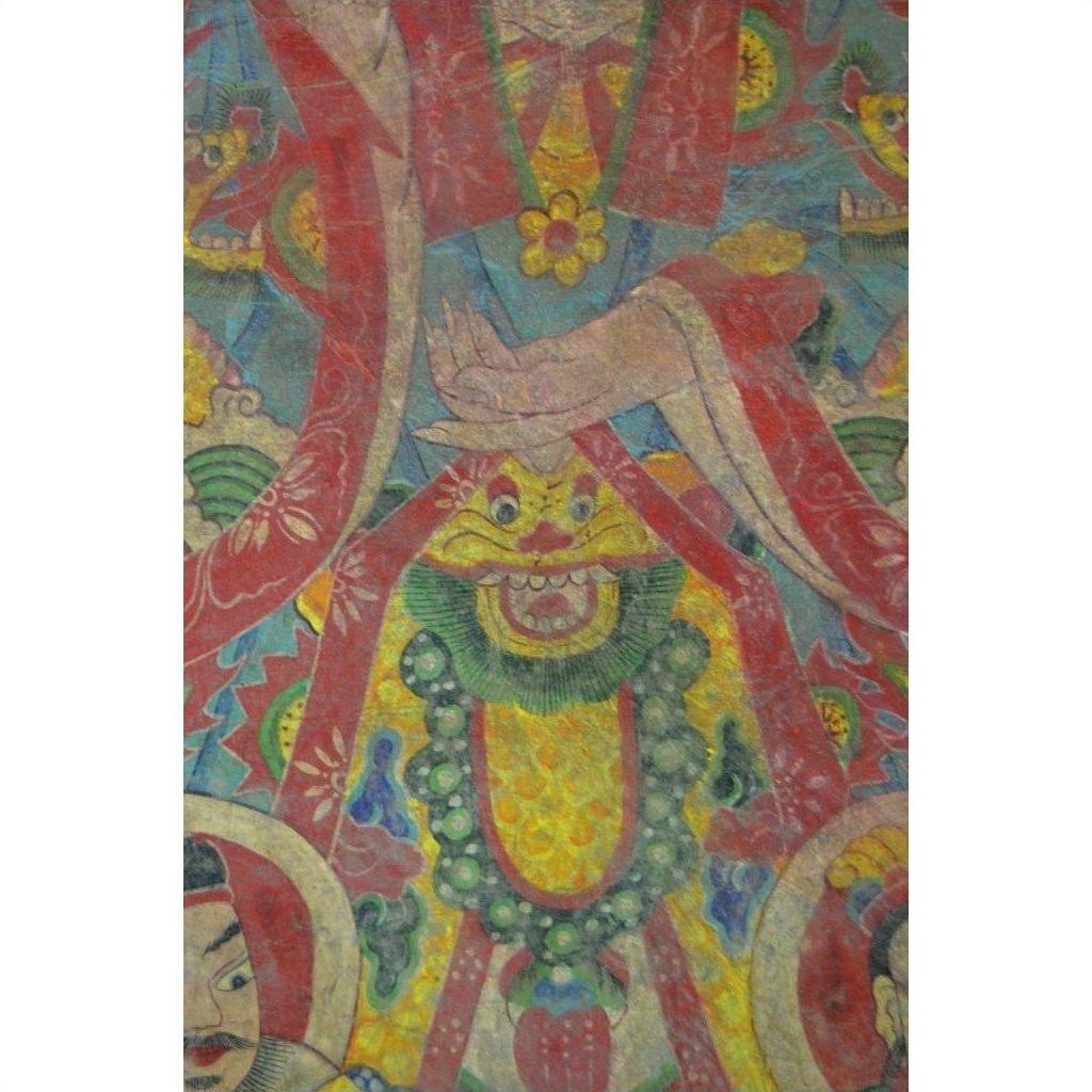 Red and green Laotian parchment painting, crossed hands, stylized face, close-up of artwork in good condition.
