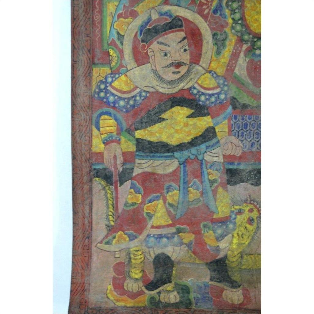 Colorful Laotian parchment painting showing a warrior in ornate armor with staff and lion, traditional art close-up.