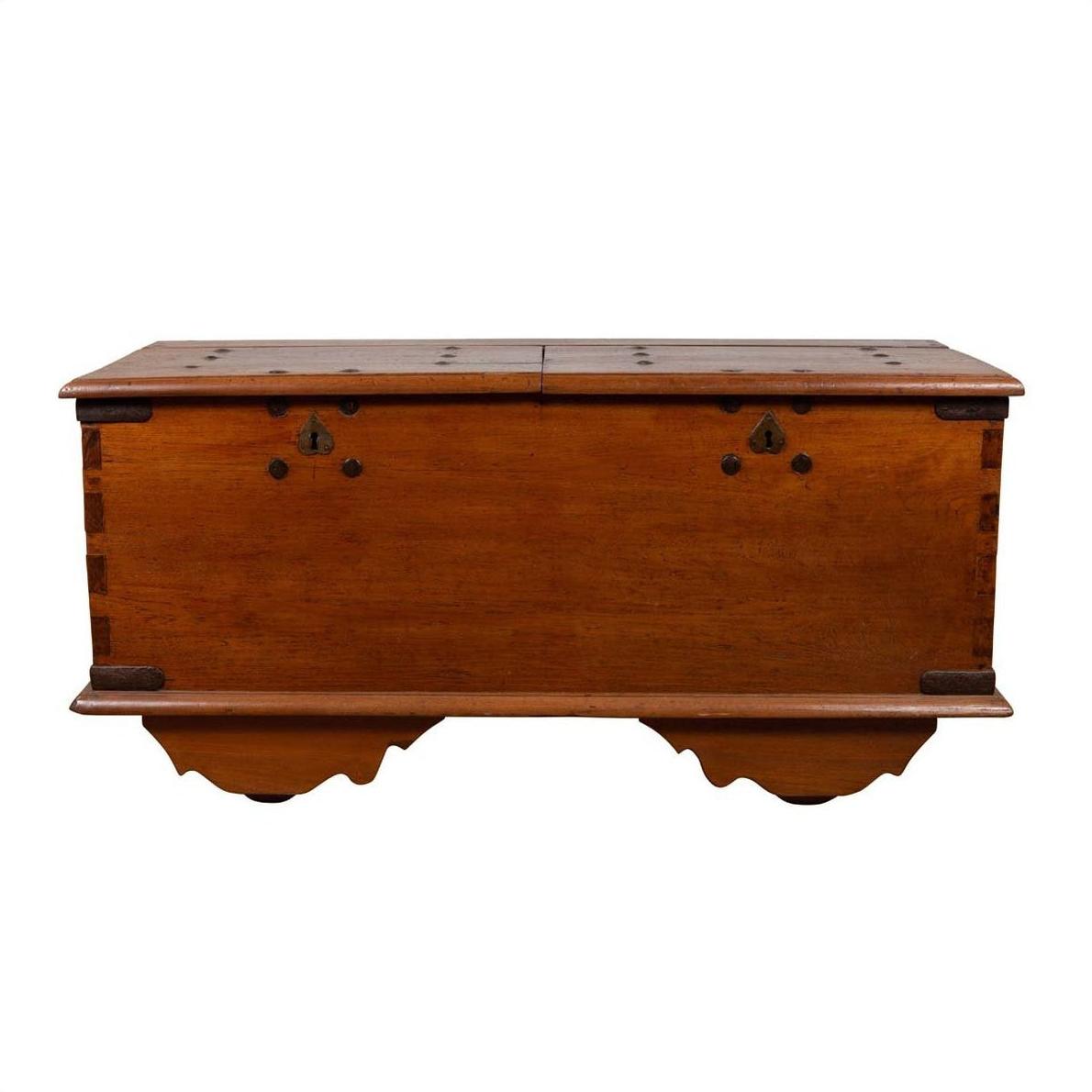 Brown teak wood blanket chest with iron nailheads and wheels, antique style, on a plain white background.