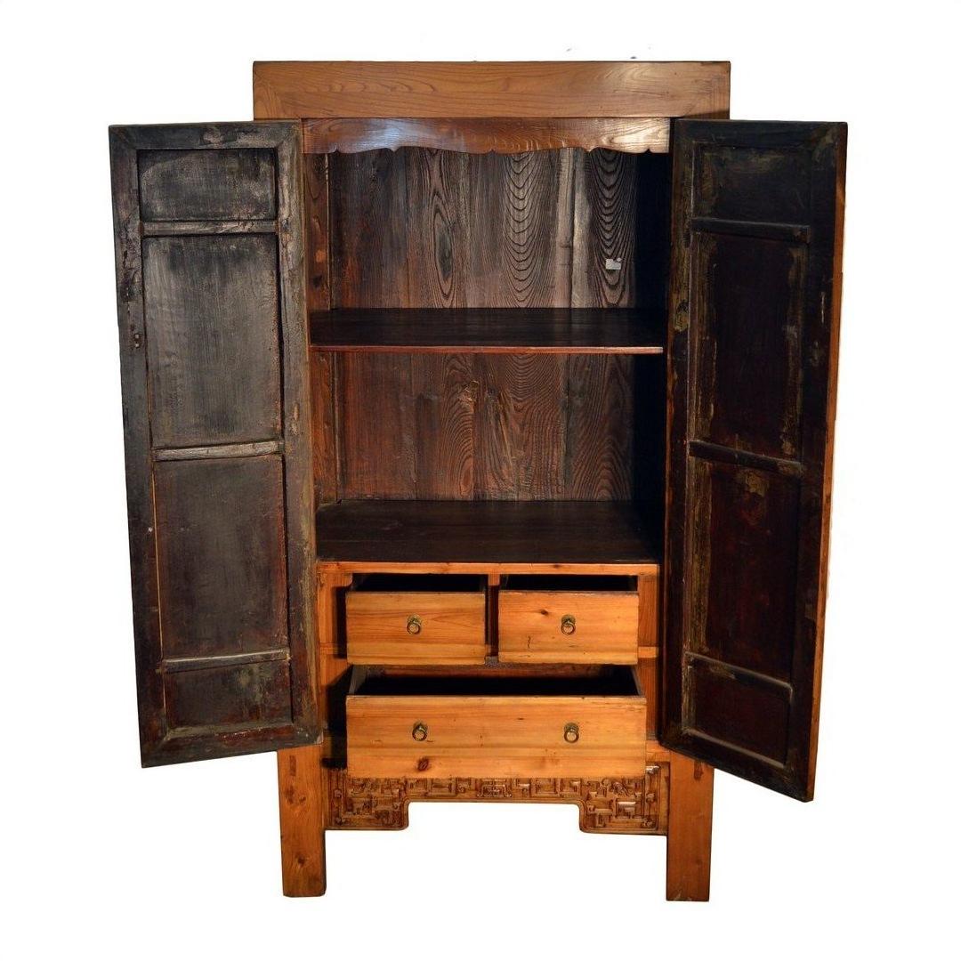 Dark wood Chinese armoire with carved panels, two open doors, two shelves, and four interior drawers, 19th century.