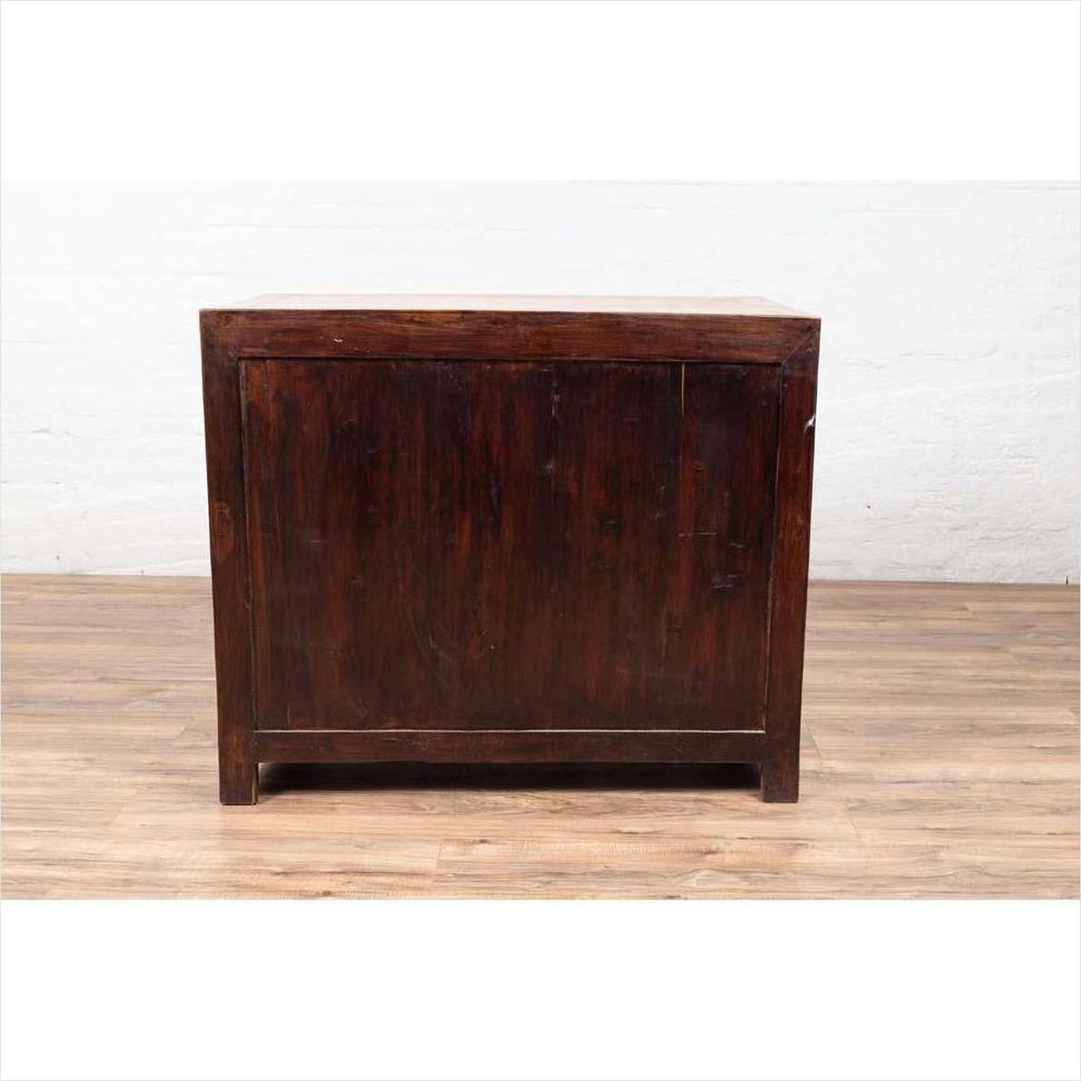 Two-toned burl and elm wood Chinese antique cabinet with doors on a wooden floor against a white wall indoors.