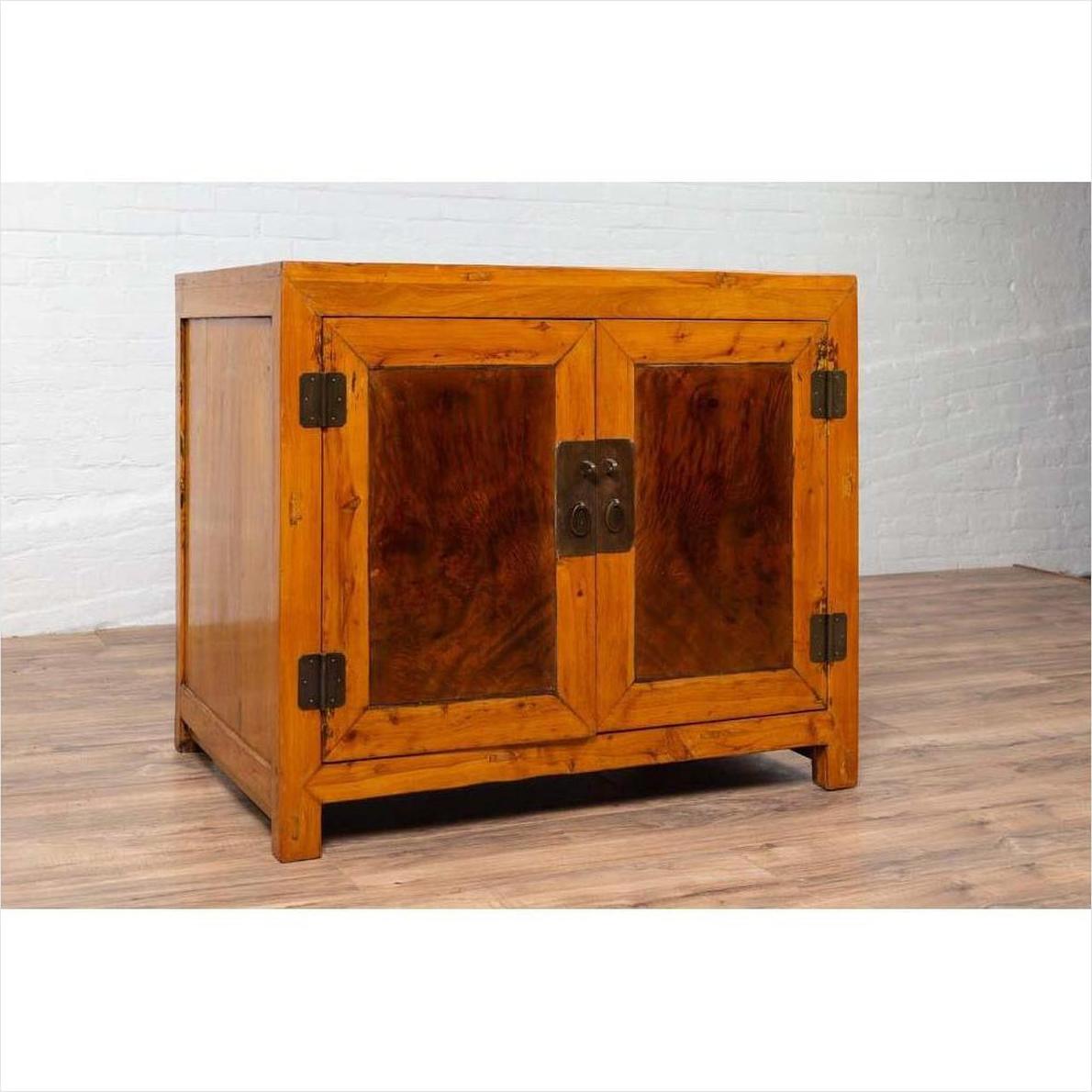 Two-toned patina burl and elm wood cabinet with doors, metal hinges, and brass lock.