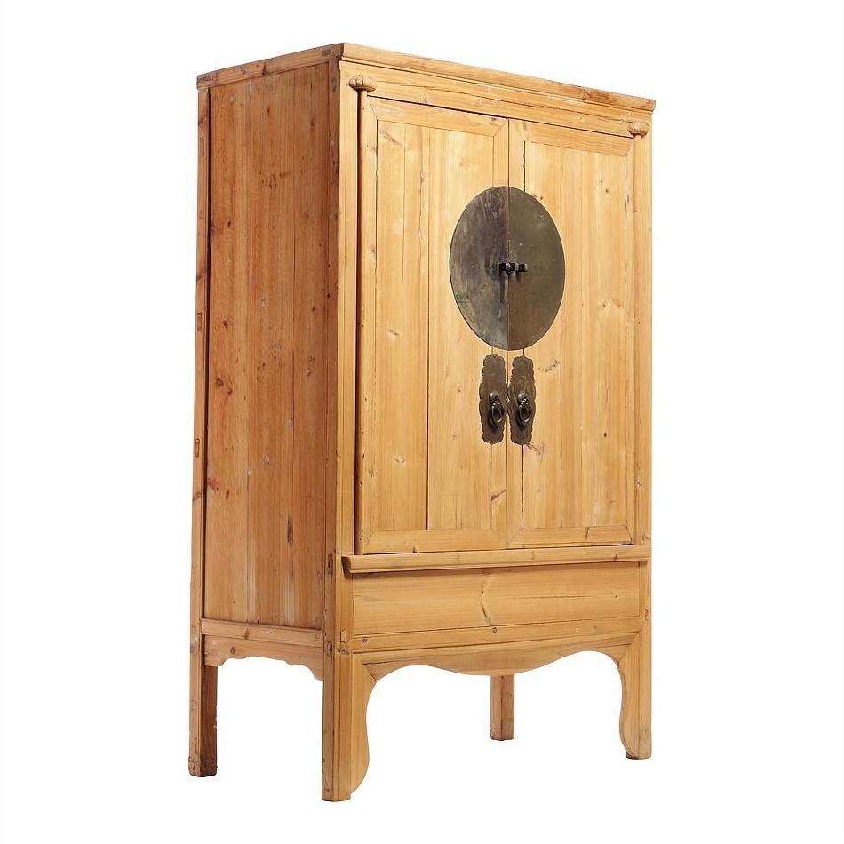 Natural wood Chinese armoire with double doors, metal medallion hardware, and decorative curved legs.