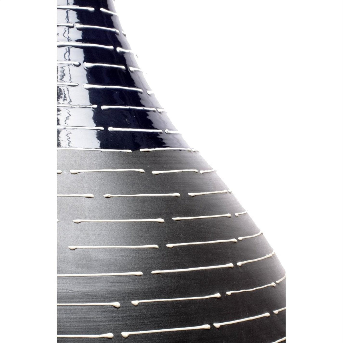 Close-up of a dark glossy ceramic Thai vase with horizontal white lines.