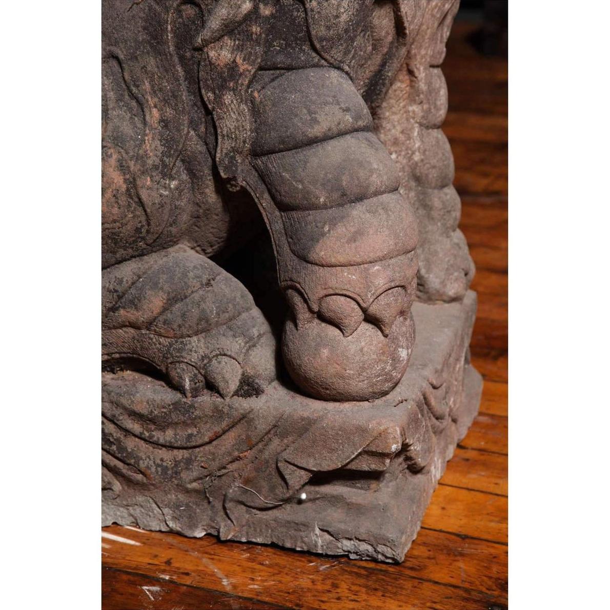 Close-up of gray stone lion paw sculpture on carved base, Late Ming Dynasty, 16th-17th century China.
