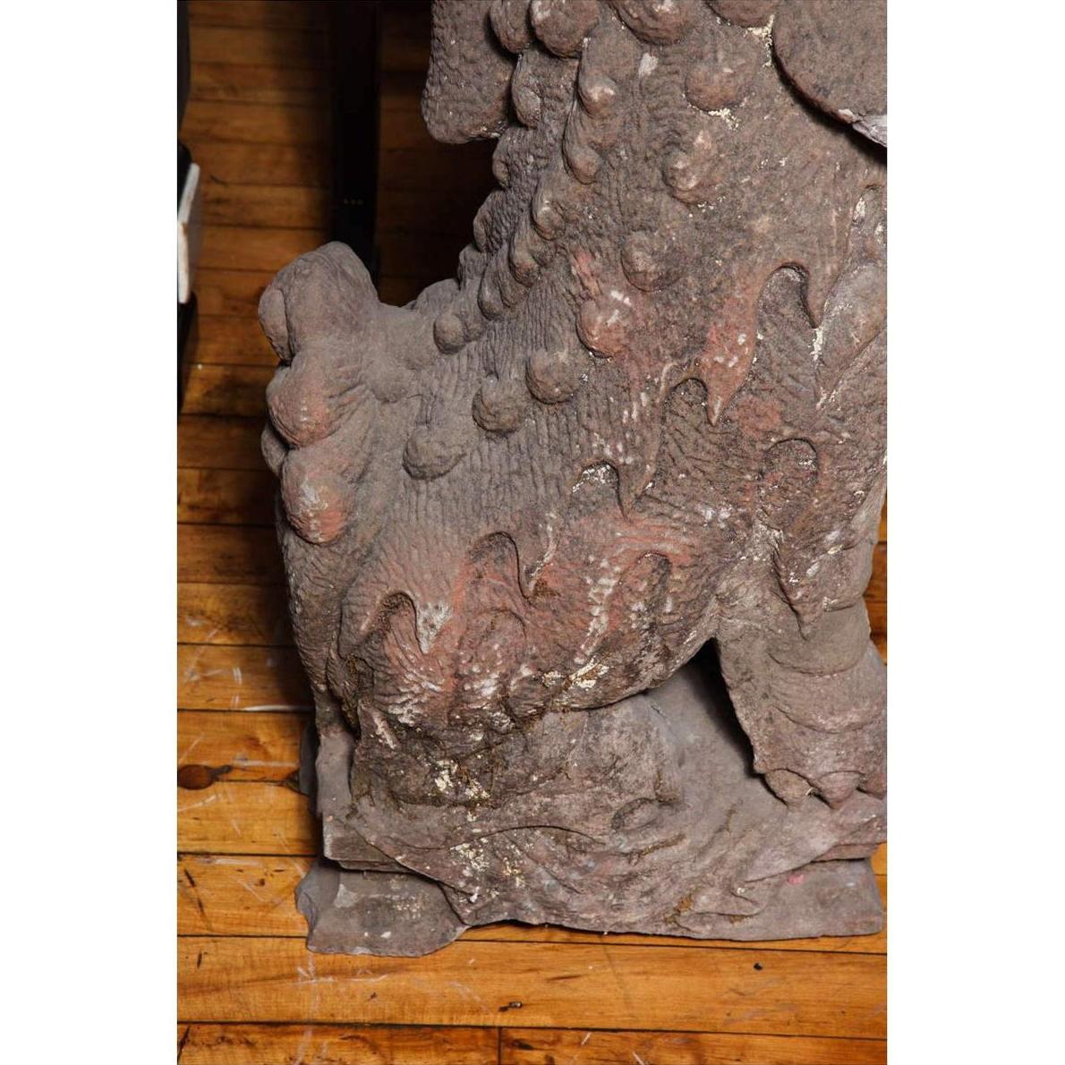 Close-up of gray stone lion paw and claws, antique, Late Ming Dynasty, on wood surface, China, 16th-17th century.