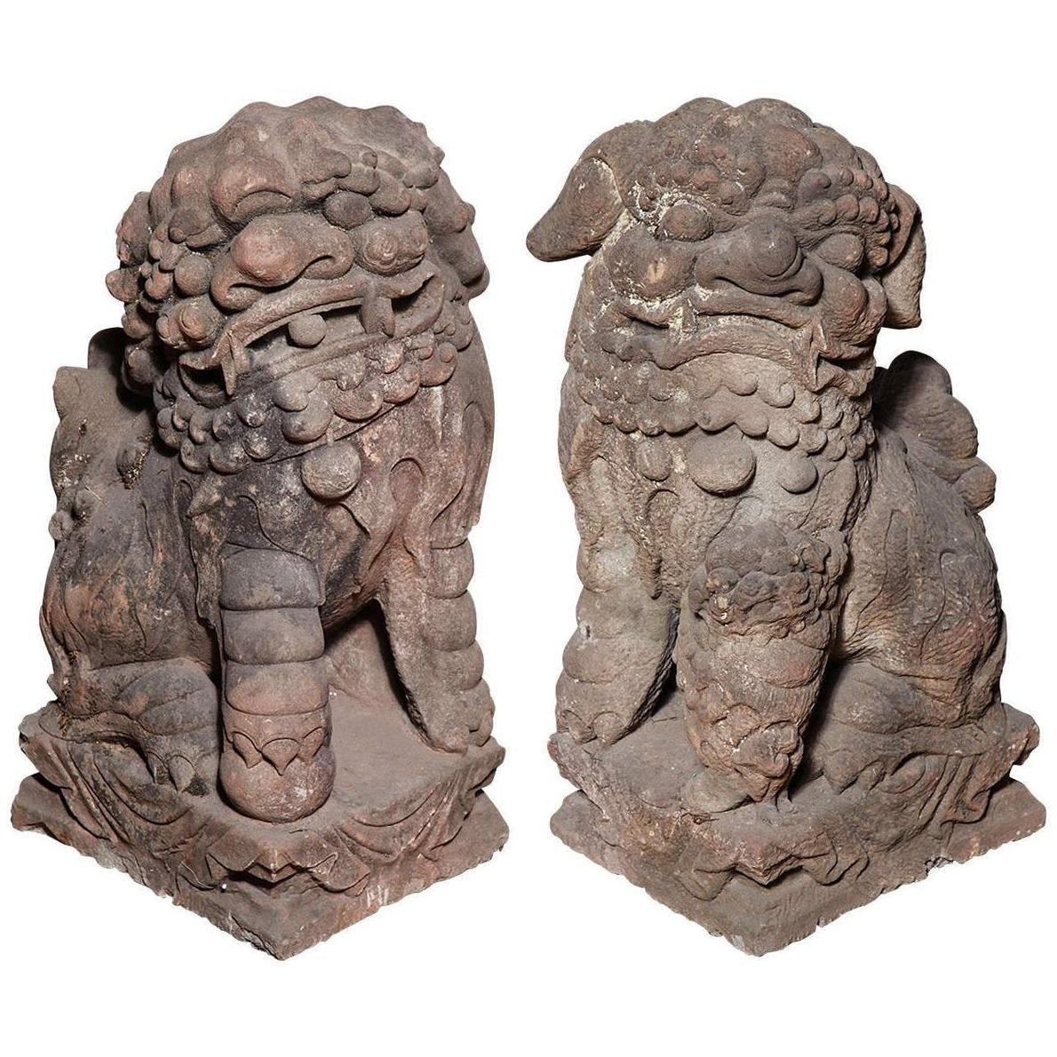 Gray stone Ming Dynasty lion statues with detailed manes, on square bases, 16th–17th century China.