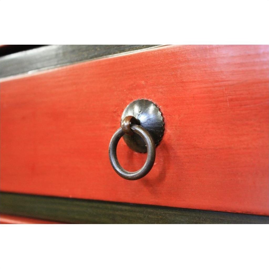 Close-up of red lacquered wood drawer on Low Side Table with central round metal ring pull handle.