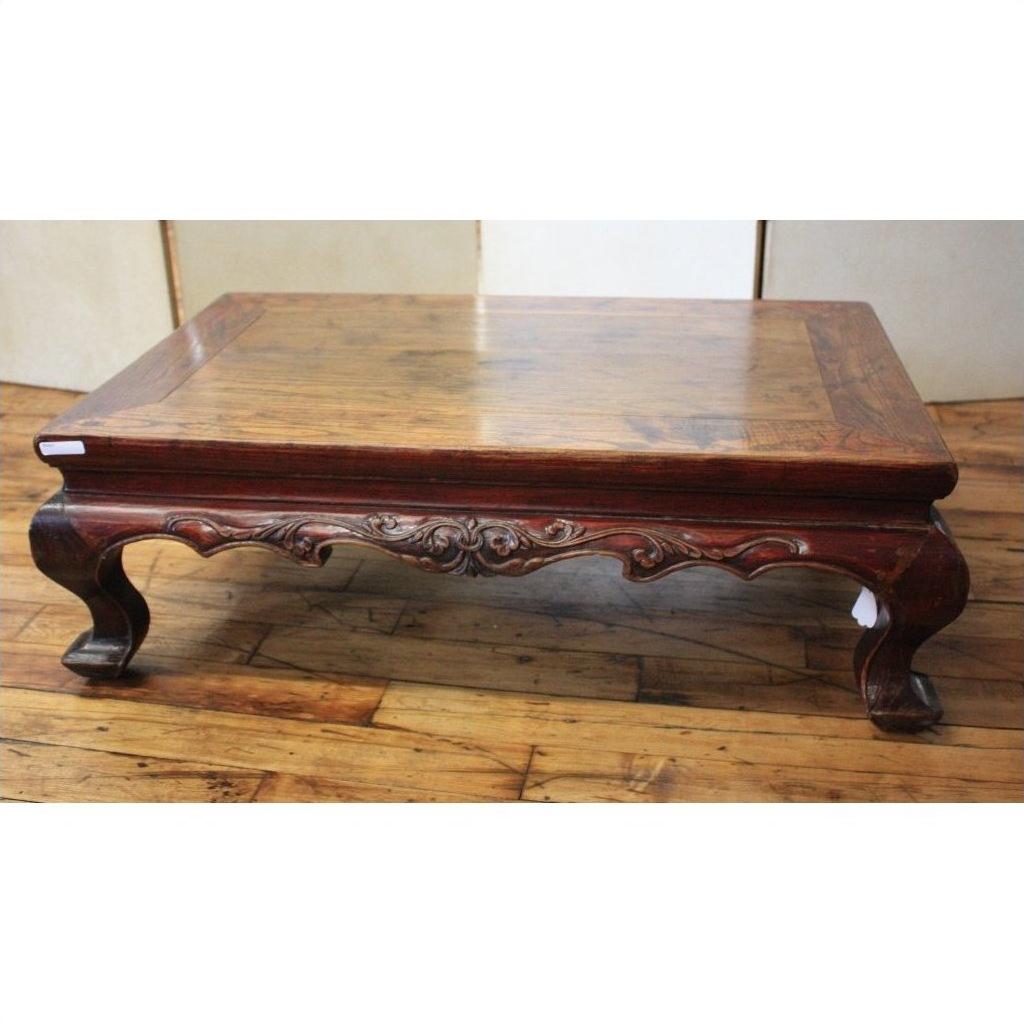 Distressed wood square table with carved elm legs, shown on wooden floor.