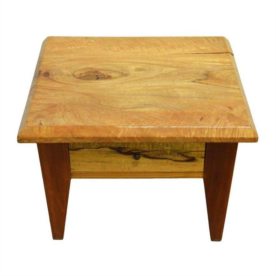 Brown mango wood side table with four legs, vintage style, and single front drawer with round brass pull.