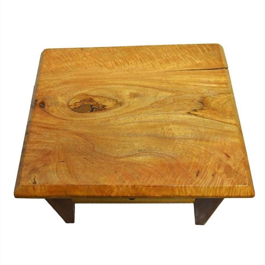 Brown mango wood side table with visible grain, front drawer, and brass pull on a white background.