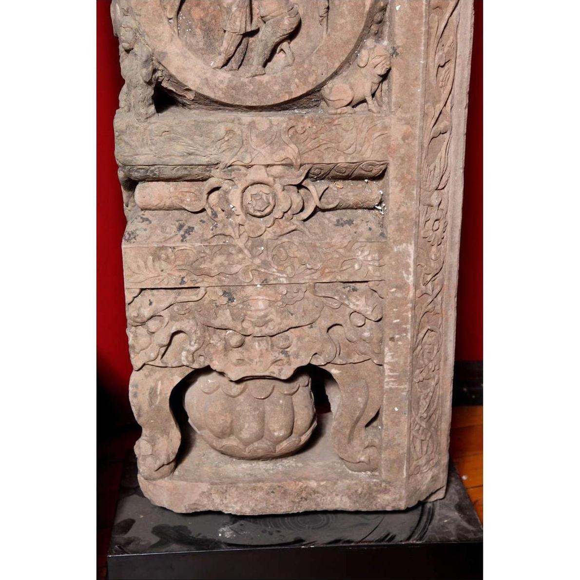 Brown wood Ming Dynasty Chinese temple carvings with figures, floral, and circular motifs on black bases, close-up.