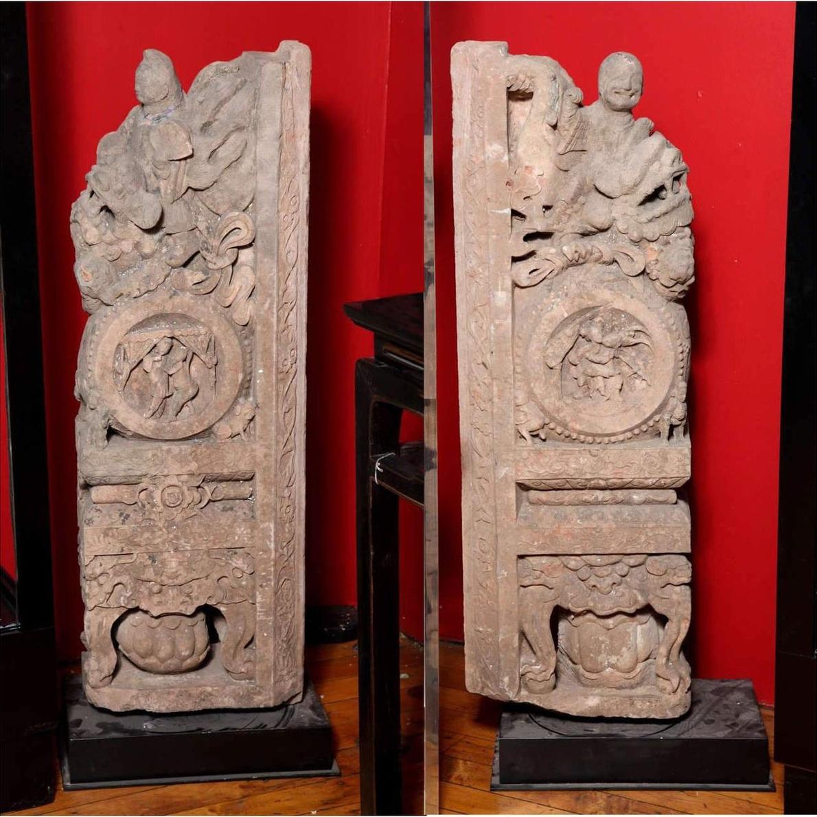 Brown wood Ming Dynasty Chinese temple carvings with figures, floral, and circular motifs on black bases, close-up.
