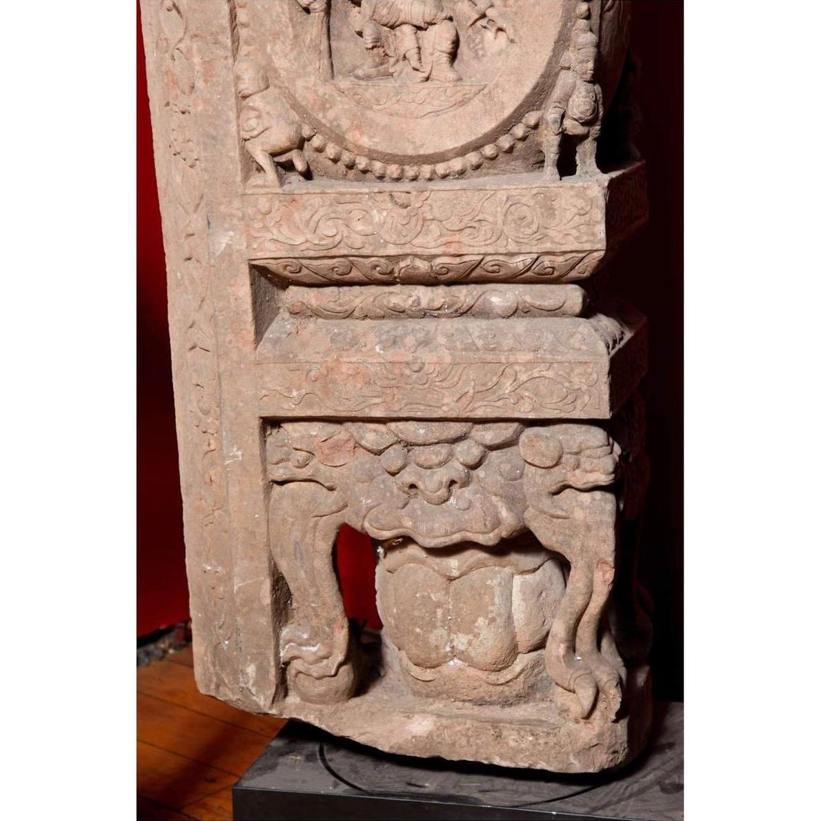 Brown wood Ming Dynasty Chinese temple carvings with figures, floral, and circular motifs on black bases, close-up.