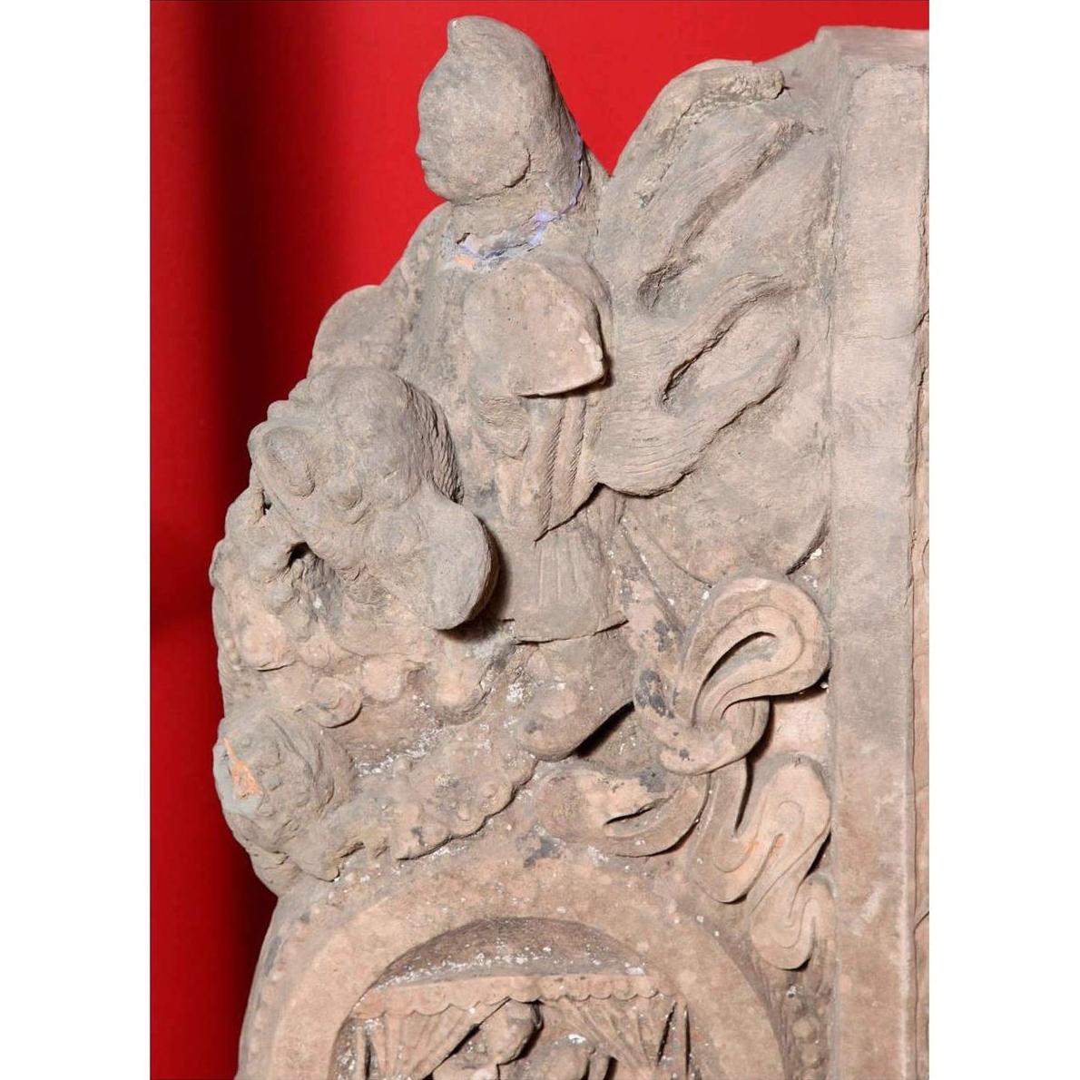 Brown wood Ming Dynasty Chinese temple carvings with figures, floral, and circular motifs on black bases, close-up.