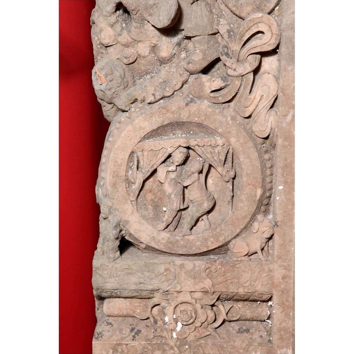 Brown wood Ming Dynasty Chinese temple carvings with figures, floral, and circular motifs on black bases, close-up.