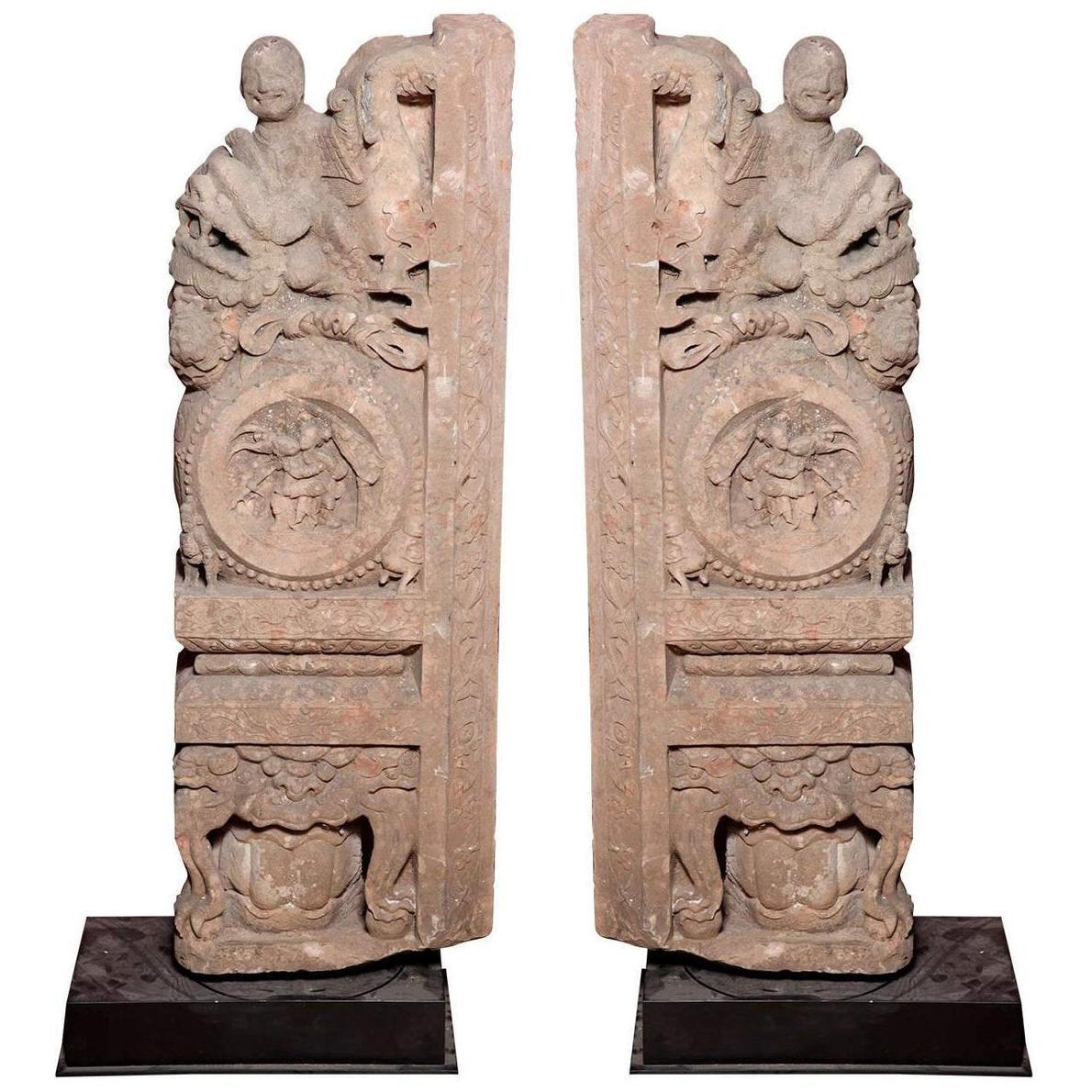 Brown wood Ming Dynasty Chinese temple carvings with figures, floral, and circular motifs on black bases, close-up.