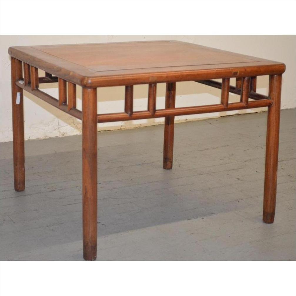 Square elmwood Ming style coffee table with geometric base design and four straight legs on gray floor.