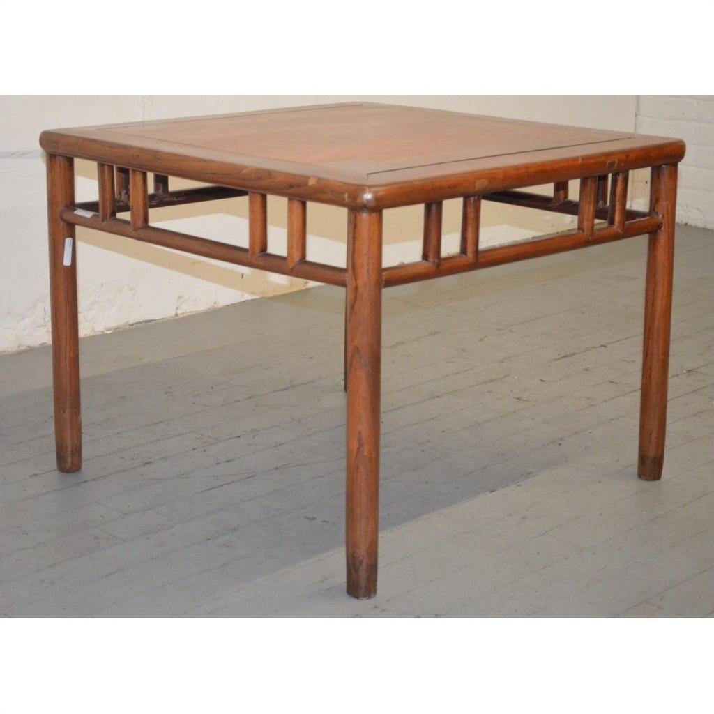 Dark wood Ming style coffee/side table with rounded legs and decorative supports on a gray wooden floor.