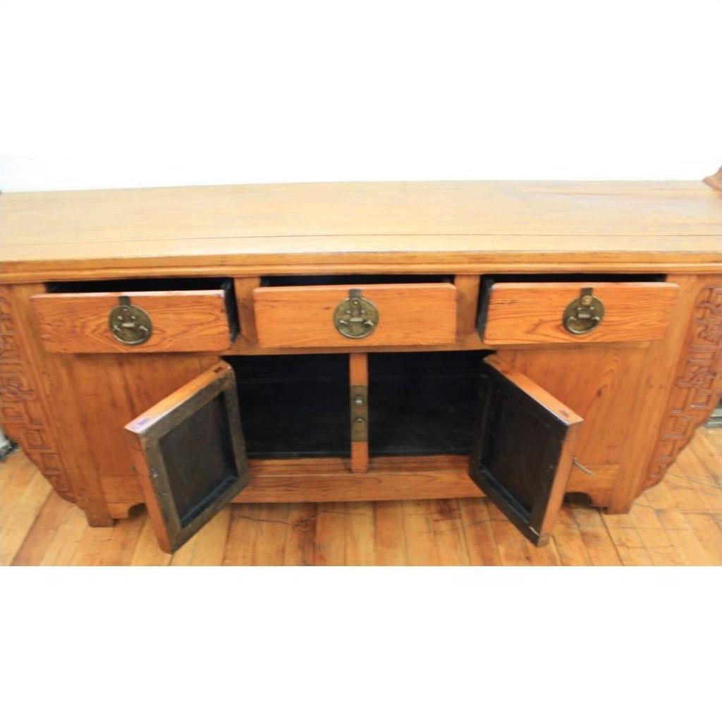 Natural wood altar coffer with three drawers, two open cabinet doors, and decorative brass hardware.