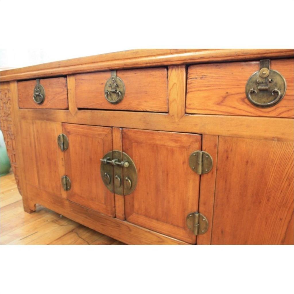Natural wood altar coffer with three drawers, two cabinets, and decorative brass hardware, front view.