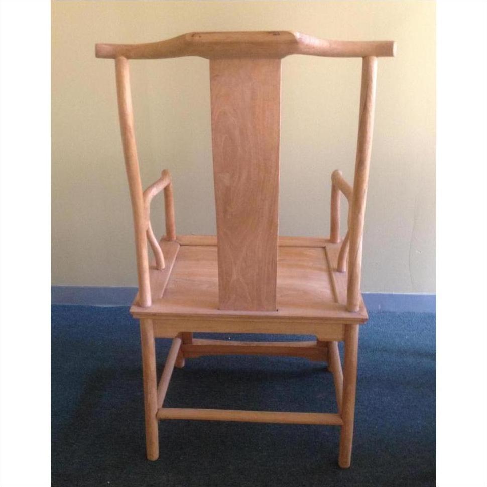 Natural wood Yoke Back Chair upside down on blue carpet, beige wall background.