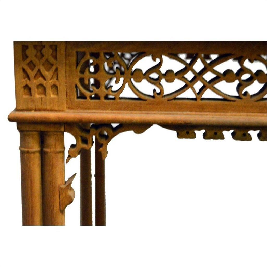 Close-up of a dark wood hand-carved table with intricate carvings and geometric patterns.