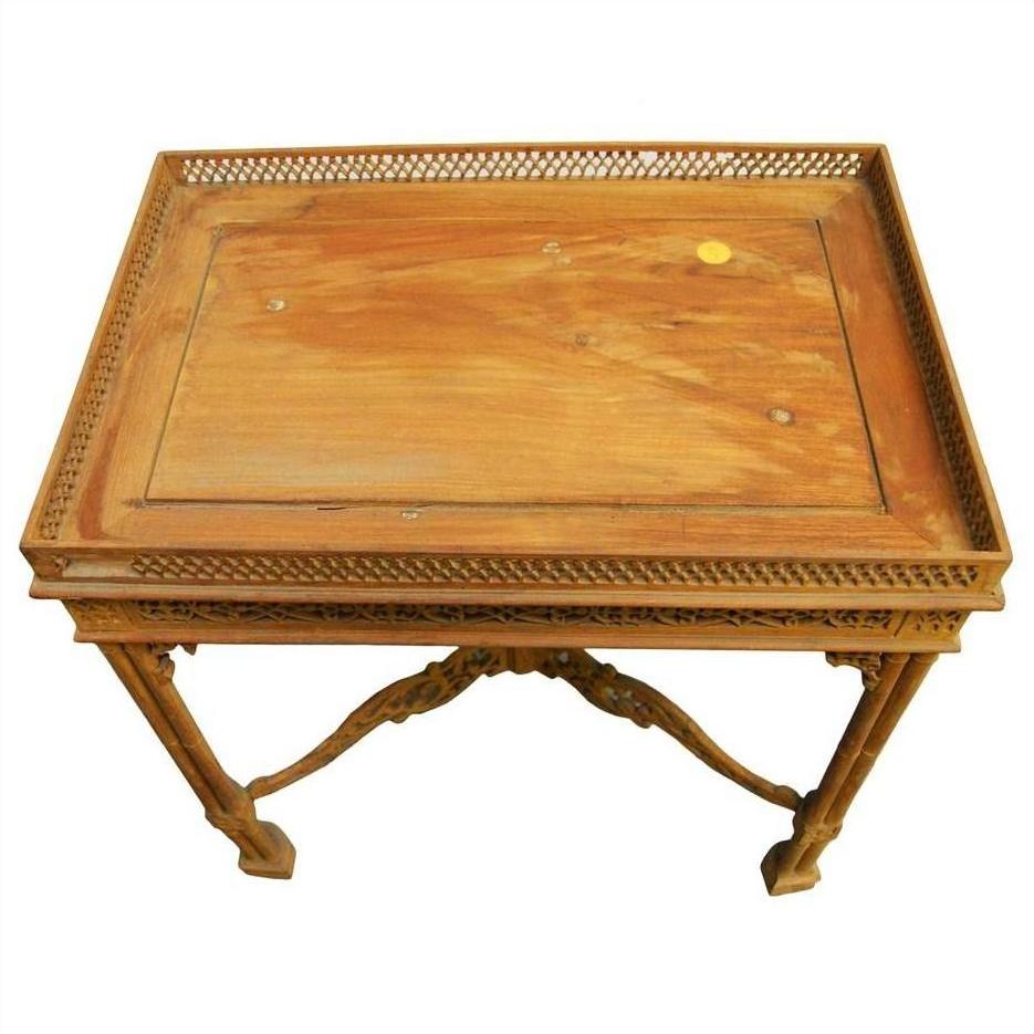 Brown wood hand-carved table with ornate carved designs, lattice sides, and detailed legs, top view.