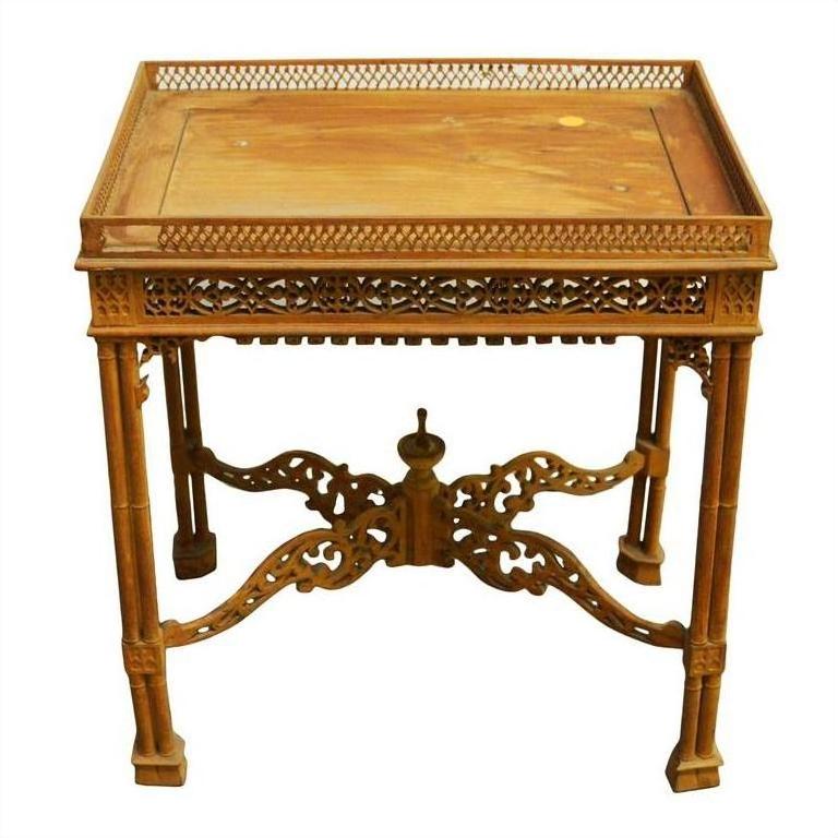 Brown wood hand carved table with ornate intricate detailing and raised decorative border on tabletop, close-up view.