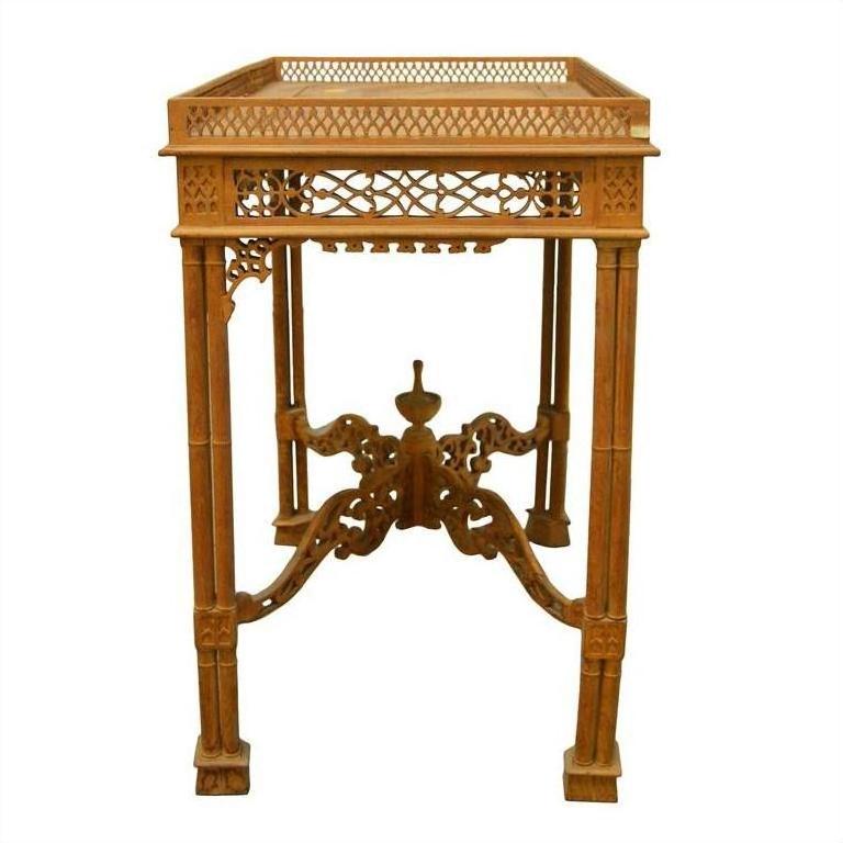 Brown wood hand-carved table with lattice design, carved details, four legs, and decorative braces.