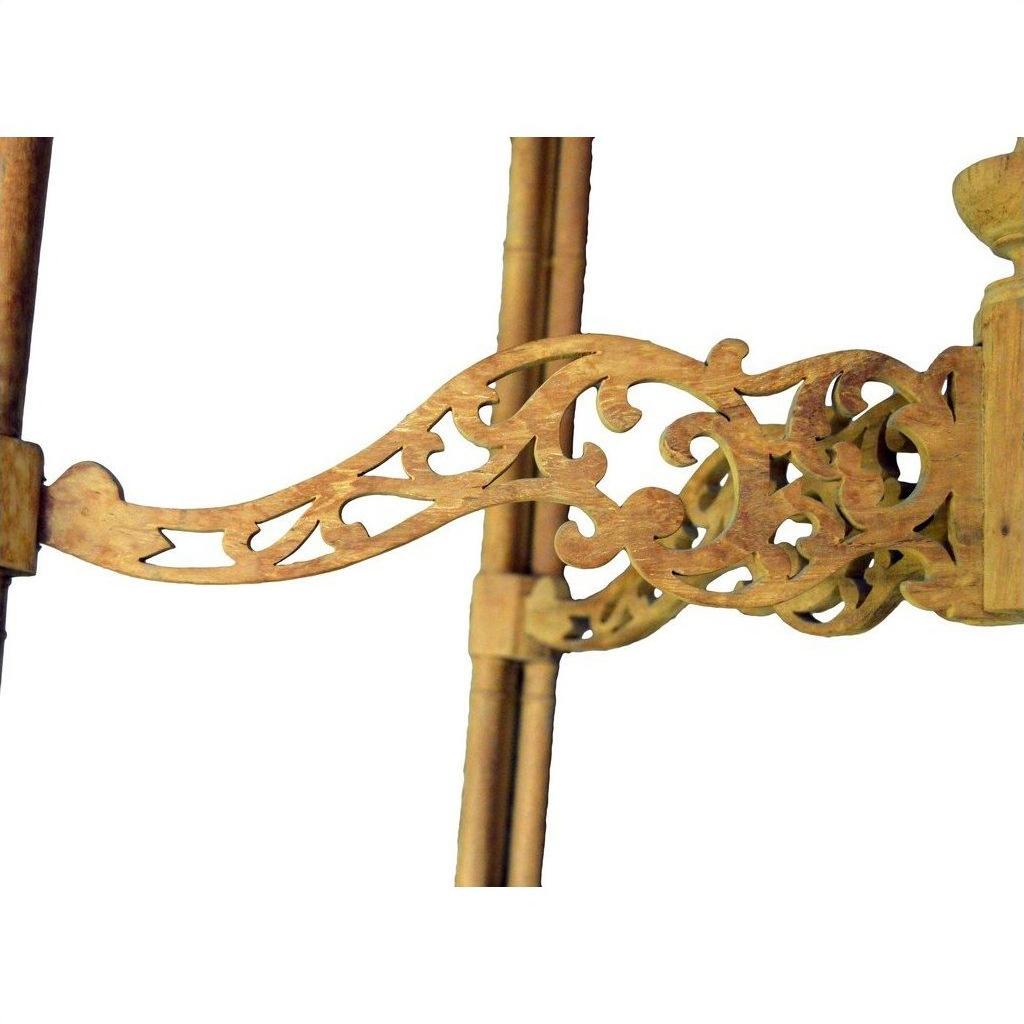 Close-up of brown wood hand carved table with intricate scrollwork and carved designs, white background.