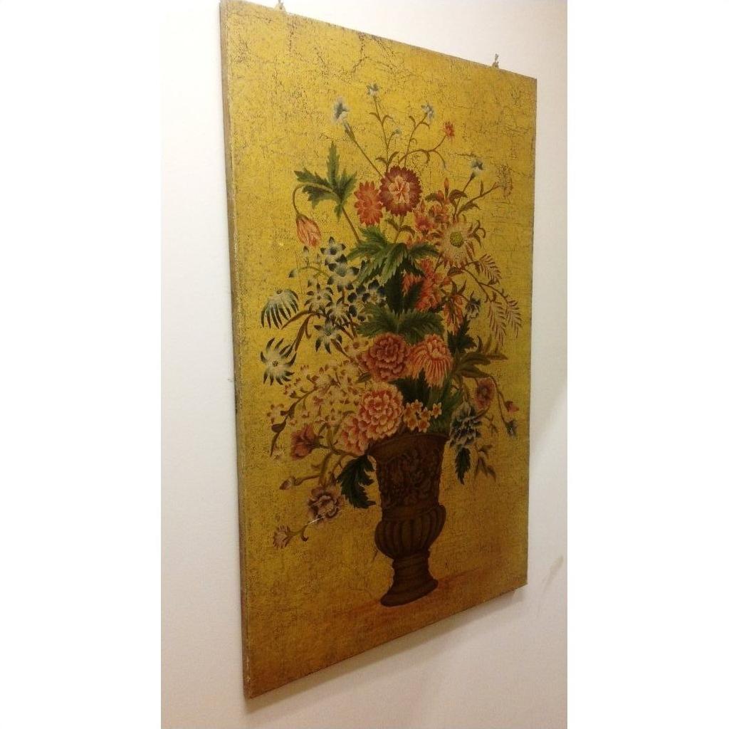 Colorful flower painting in an urn vase on a yellow background, displayed against a white wall.