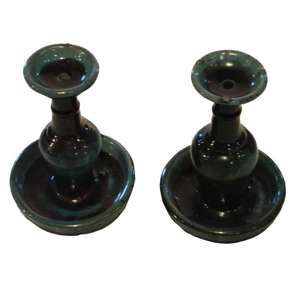 Green glazed ceramic antique Chinese Hunan candle holders, pair displayed side by side on white background.