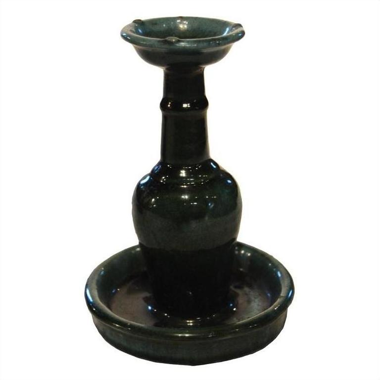 Dark green glazed ceramic antique Chinese Hunan candle holders with narrow necks and wide bases, on white background.