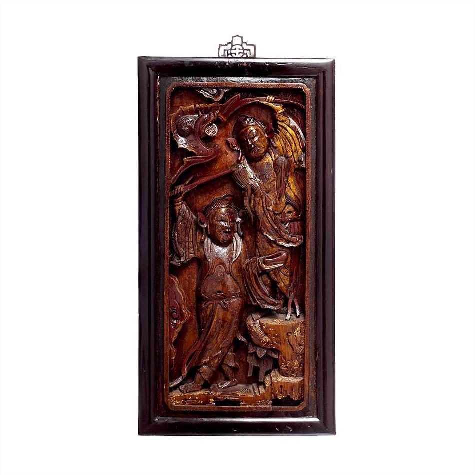 Dark wood Chinese carvings, two intricately carved robed figures framed, displayed on white background, close-up.