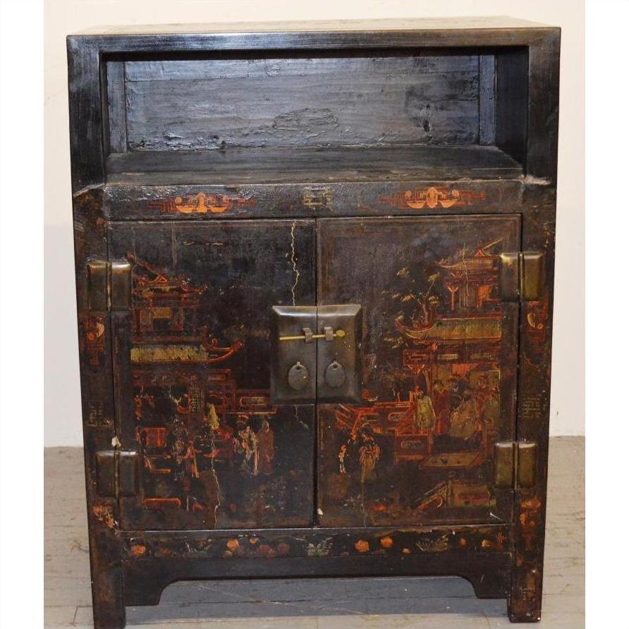 Black lacquer antique Chinese display cabinet with faded red and gold motifs, double doors, open shelf design.