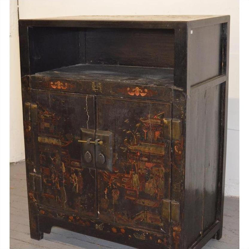 Black lacquer display cabinet with Asian motifs, two doors, metal lock, and open shelf, antique style.