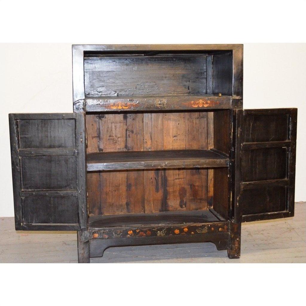 Black display cabinets with floral accents and open shelves, doors open, shown indoors.