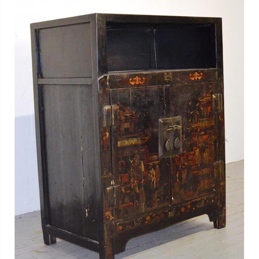 Black lacquered wood Chinese display cabinet with open shelves, metal latch, and two doors against white wall.