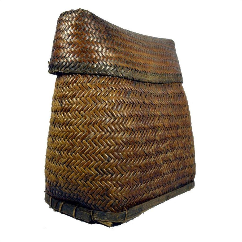 Close-up of brown handwoven rattan basket with wide base and slightly folded top, Philippines style.
