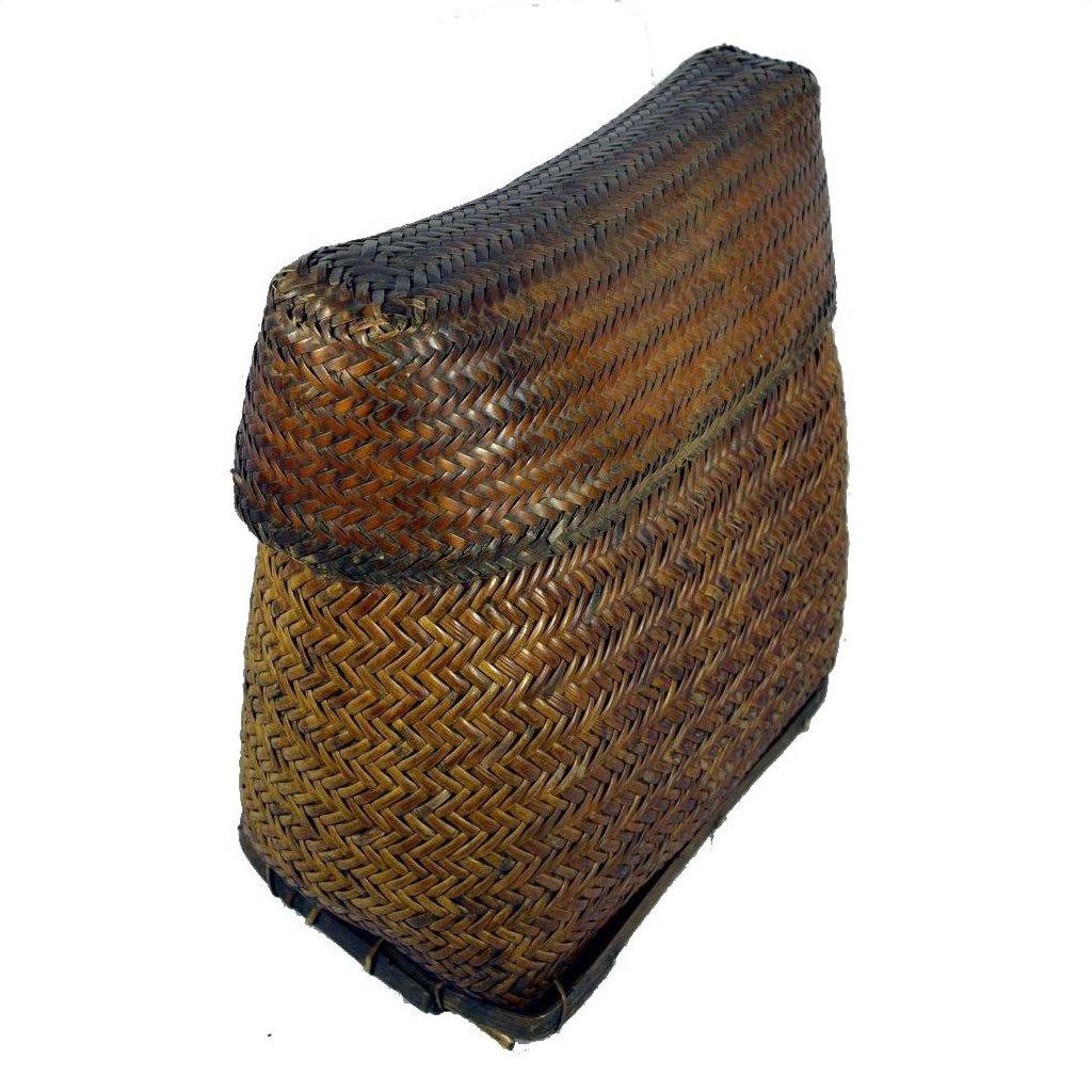 Brown rattan rectangular basket with curved lid and herringbone pattern, close-up.
