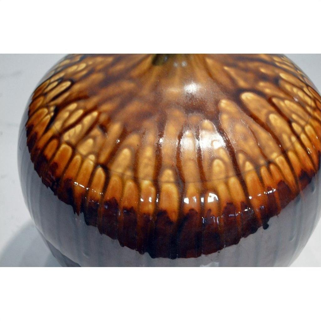 Close-up of brown and tan ceramic jar with drip pattern, Prem Collection, artisan design, isolated on neutral background.