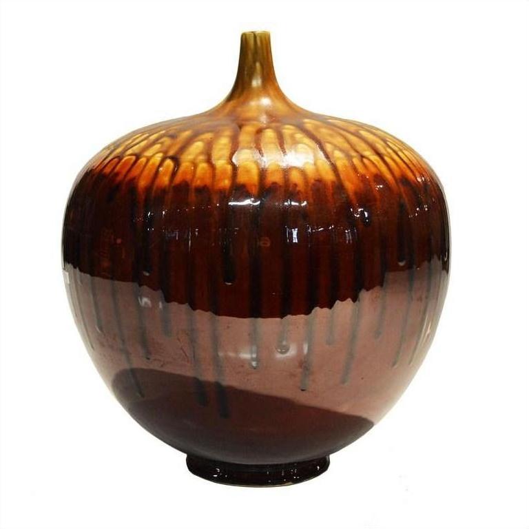 Brown and amber ceramic jar with short neck and subtle vertical drip patterns, close-up view.