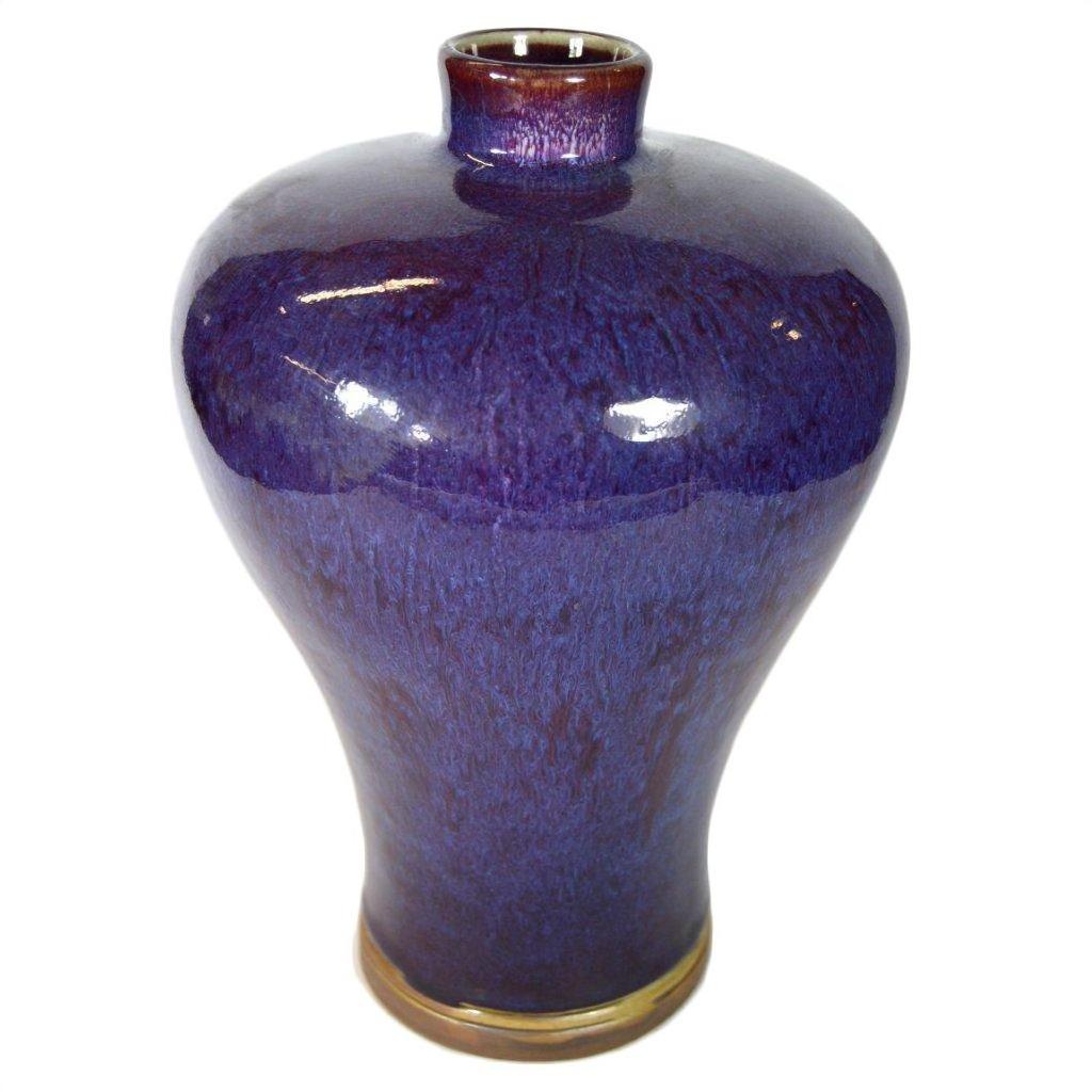 Close-up of deep blue glazed ceramic vase with glossy finish, narrow neck, wide body; very good condition.