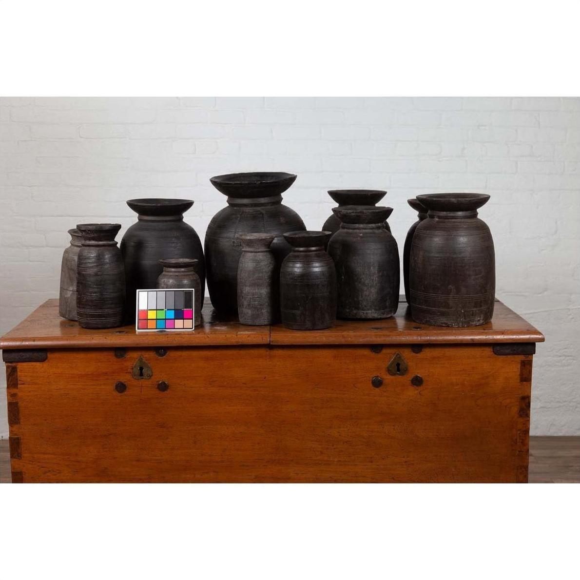 Brown wooden ghee pots displayed on a chest with a color card in front, set of 3, 5, or 7.