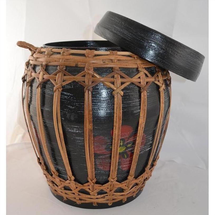 Natural rattan and bamboo lidded basket with woven cover and partially open lid, close-up view.