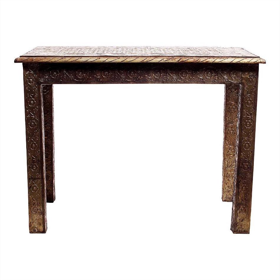 Silver hammered metal rectangular table with intricate carved legs and top, displayed on white background.
